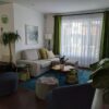 a living room filled with furniture and a large window