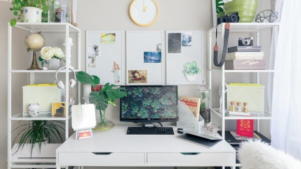 turned on flat screen monitor white wooden desk
